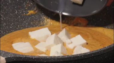 Shahi paneer in rich creamy gravy garnished with cream